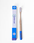 Bamboo toothbrush next to recyclable toothbrush packaging