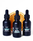 Three bottles of Vitamin C serum 15% ascorbic acid in dark bottle with dropper
