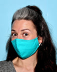 Woman wearing etee teal face mask