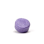 A purple round lavender chamomile shampoo bar