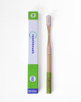 Bamboo toothbrush next to recyclable toothbrush packaging