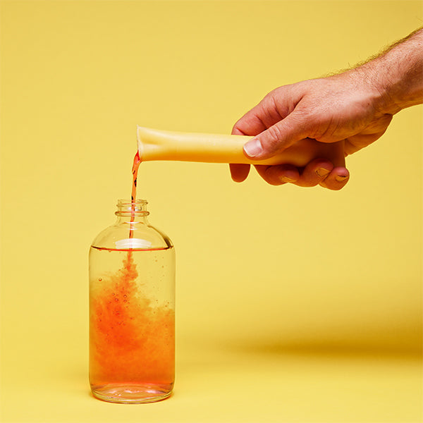 all purpose cleaner concentrate liquid being poured into a dispenser