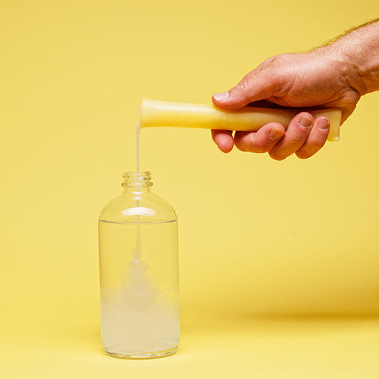 floor cleaner concentrate liquid being poured into a dispenser