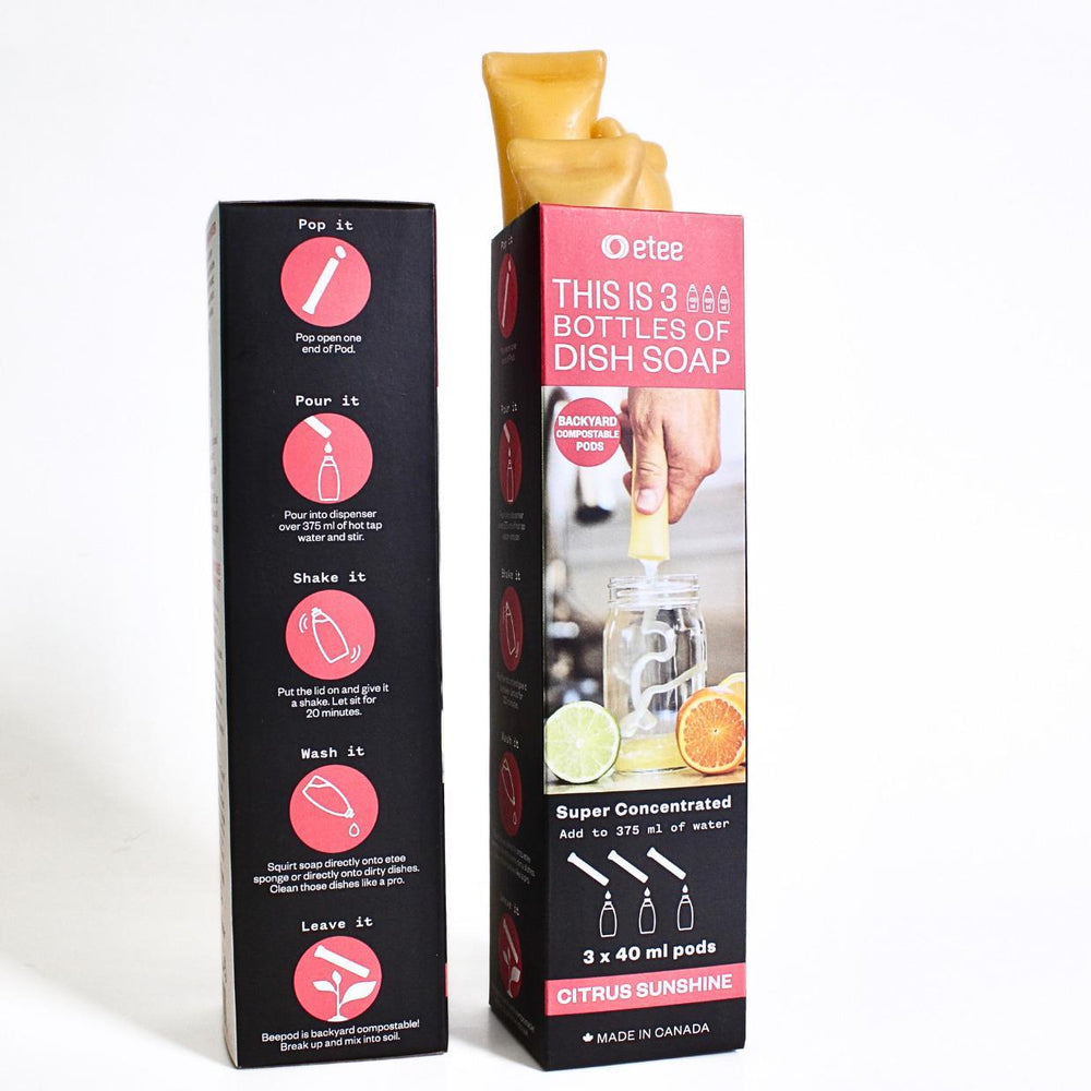 Two boxes, each with three beeswax tubes filled with concentrated citrus dish soap