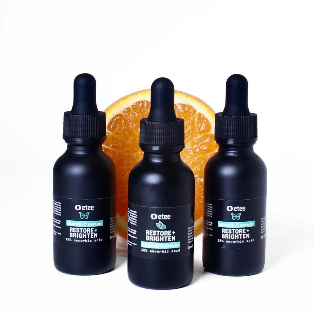 Three bottles of Vitamin C serum 15% ascorbic acid in dark bottle with dropper
