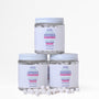 Three tubs of etee fluoride chewpaste stacked on top of each other with about 20 chewpaste tablets strewn in front of the jars