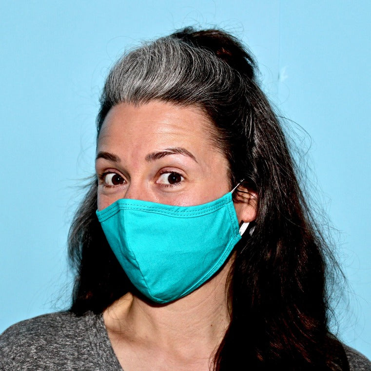 Woman wearing etee teal face mask
